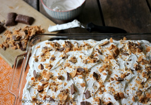 Butter Pecan Cake: Yellow Poke Cake flavored with Southern Butter Pecan Creamer, topped with Fluffy Frosting and chopped Butterfinger Candy Bars | Recipe on HoosierHomemade.com