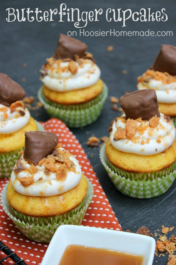 Butterfinger Cupcakes - golden butter cake mix, filled with caramel and topped with Vanilla Buttercream Frosting, a drizzle of caramel and chopped Butterfinger candy bars! Pin to your Recipe Board!