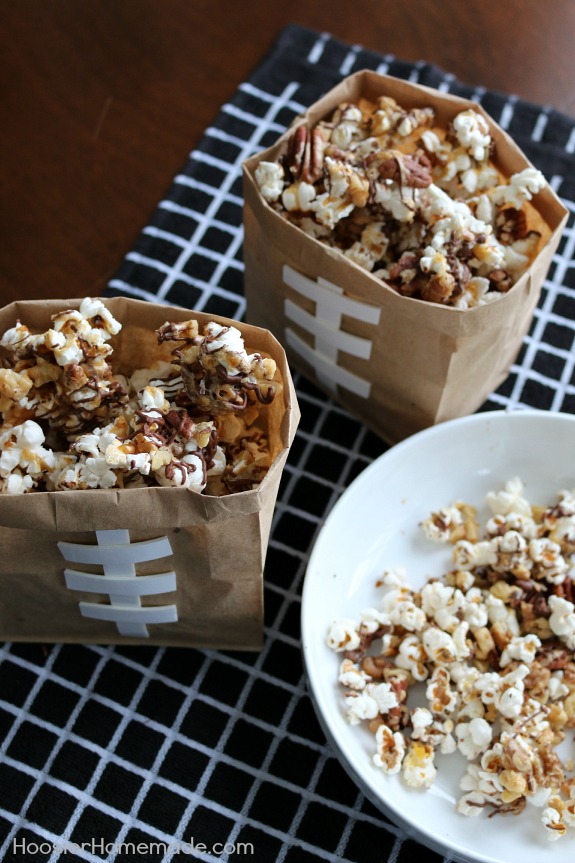 Treat your Football Fans to this Chocolate Caramel Nut Popcorn! It's the perfect sweet - salty snack for the Big Game! Pin to your Recipe Board!