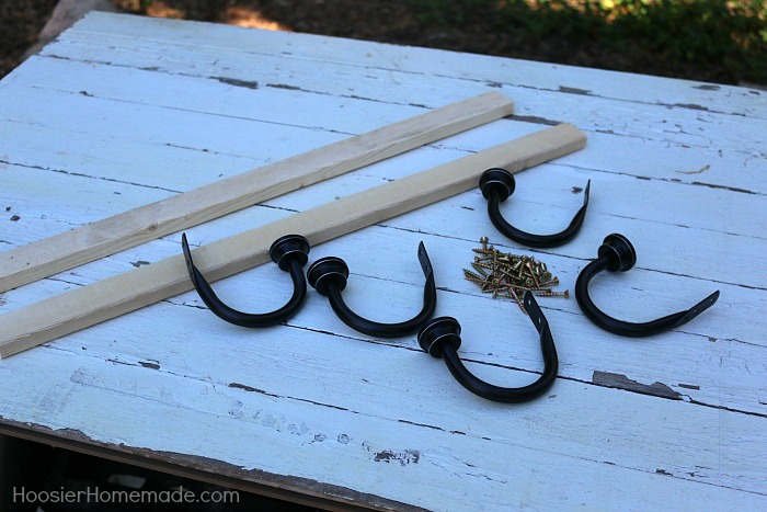 DIY COAT RACK -- This easy to make Farmhouse Coat Rack uses old barn wood and curtain tie backs! Build this coat rack for under $25! 