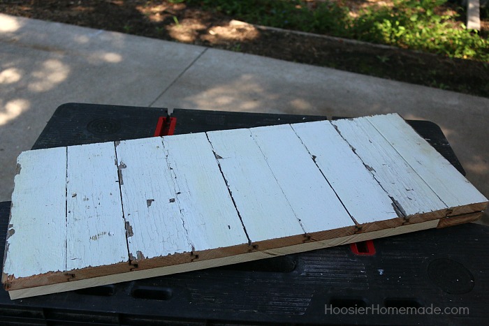 DIY COAT RACK -- This easy to make Farmhouse Coat Rack uses old barn wood and curtain tie backs! Build this coat rack for under $25!