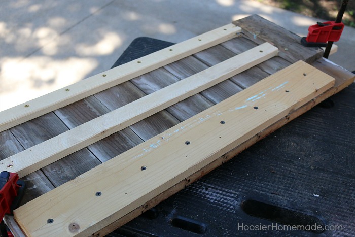 DIY COAT RACK -- This easy to make Farmhouse Coat Rack uses old barn wood and curtain tie backs! Build this coat rack for under $25!