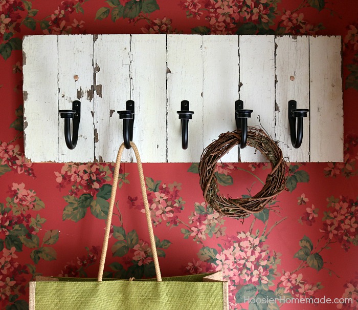 DIY COAT RACK -- This easy to make Farmhouse Coat Rack uses old barn wood and curtain tie backs! Build this coat rack for under $25! 