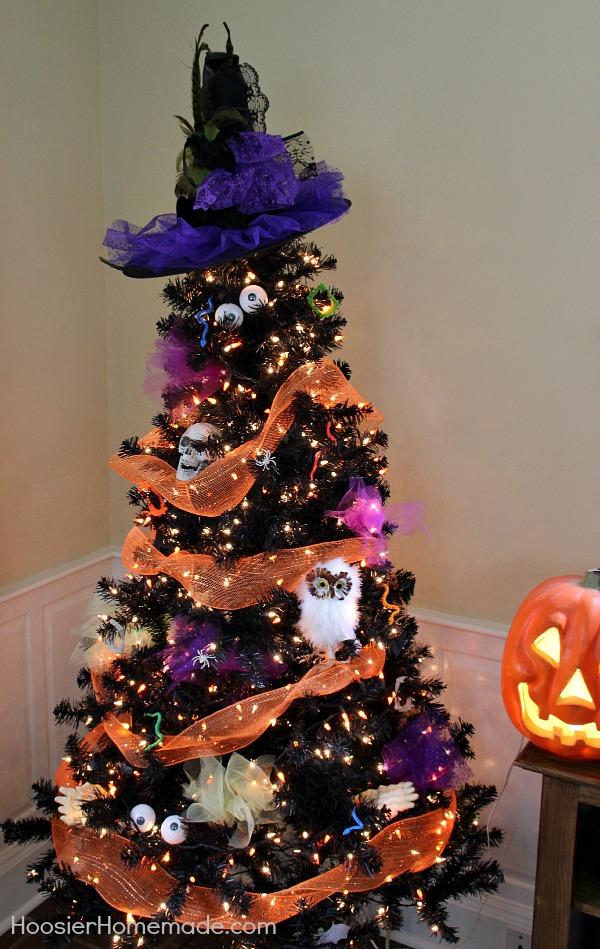 Halloween Tree - Orange Deco Mesh, Skulls, Eyes, Spiders and more are used to decorate the Halloween Tree, and topped with a cool Witches Hat. Get ready for the ghosts and goblins with this easy to make Halloween Decoration.