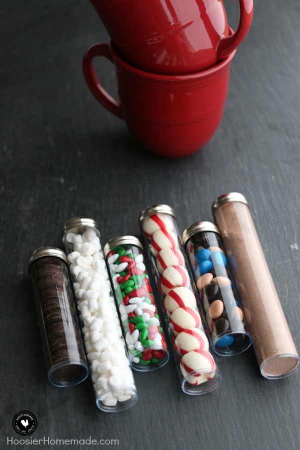 This adorable Christmas Gift is perfect for teachers, neighbors, co-workers and more! Fill with your favorite Hot Chocolate toppings! Put together these Hot Cocoa Kits in minutes! Add a special mug and you have a great affordable Christmas gift idea! 