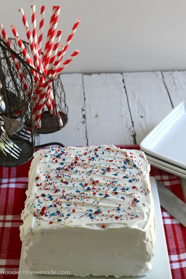 Ice Cream Sandwiches Cake -- this fun red, white and blue ice cream sandwiches cake is super easy and really fun for your 4th of July Celebrations! Just 4 simple ingredients and you have a show-stopping dessert! 