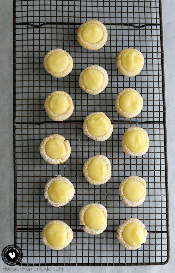 Lemon Drop Cookies - buttery cookies filled with homemade lemon curd! Perfect for Easter Dessert, a Spring treat, and are perfect for a baby or bridal shower! Pin to your Recipe Board!