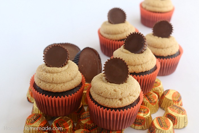 PEANUT BUTTER CUP CUPCAKES -- These Chocolate Cupcakes start with a moist, delicious recipe that includes peanut butter cups in the cupcakes, and topped with a creamy Peanut Butter Frosting! And of course, another Peanut Butter Cup on top!
