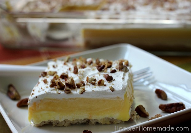 Pumpkin Cream Cheese Layered Dessert | Layers of cream cheese, whipped topping, pudding, and pecans on top of a sweet crust | Recipe on HoosierHomemade.com