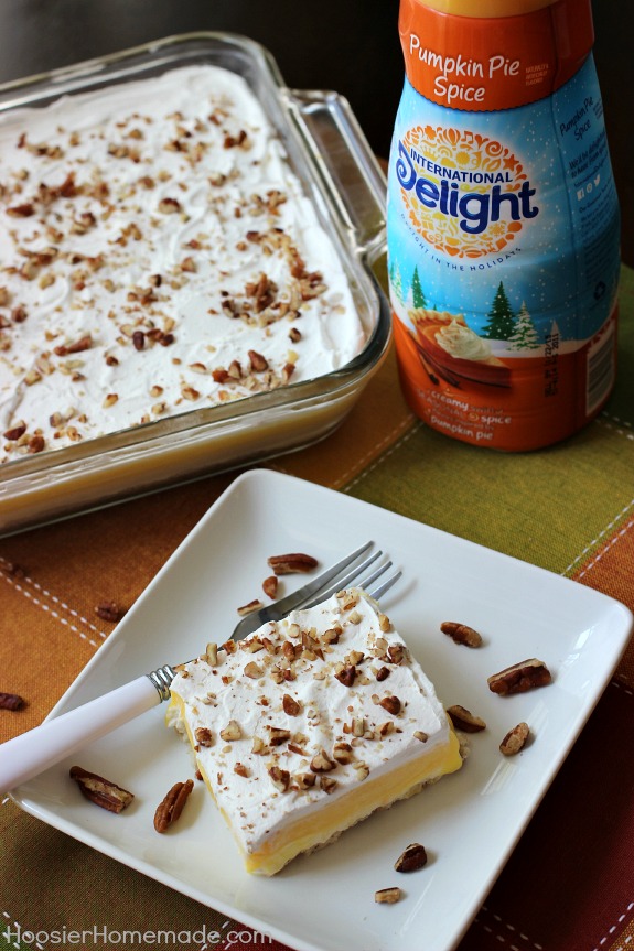 Pumpkin Cream Cheese Layered Dessert | Layers of cream cheese, whipped topping, pudding, and pecans on top of a sweet crust | Recipe on HoosierHomemade.com