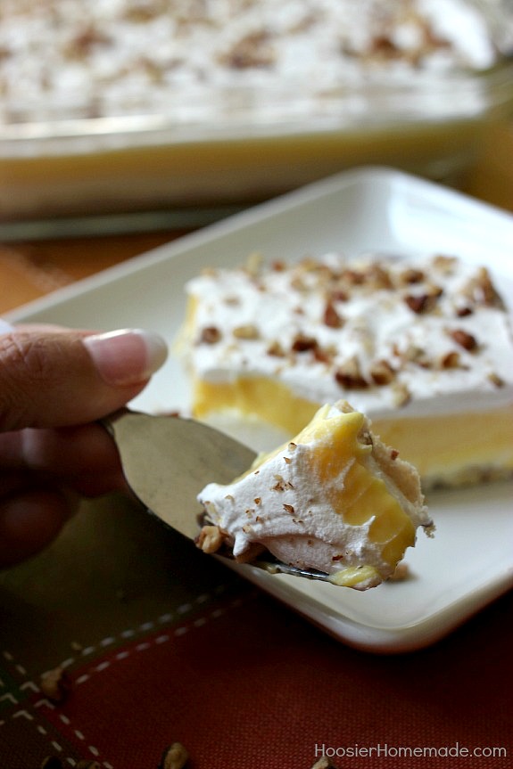 Pumpkin Cream Cheese Layered Dessert | Layers of cream cheese, whipped topping, pudding, and pecans on top of a sweet crust | Recipe on HoosierHomemade.com