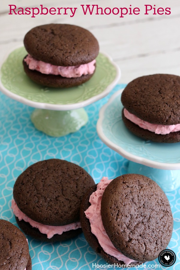 Raspberry Whoopie Pies - fluffy raspberry filling sandwiched between 2 chocolate cookies! Be sure to save room! You won't want to miss this one! Pin to your Recipe Board!