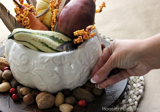 Add nuts and cranberries around the base of the centerpiece