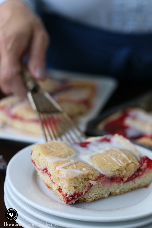 These Strawberry Cobbler Bars will knock your socks OFF! They are super simple to make and taste amazing! Serve them for any occasion, take them to a potluck or easy enough for a weeknight dessert! 