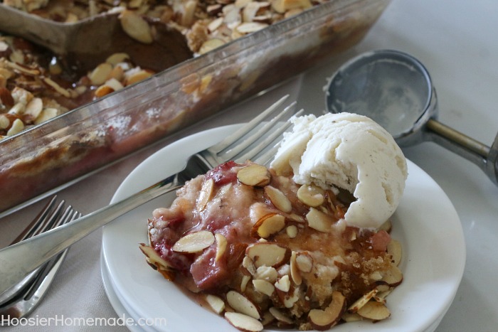 Strawberry Rhubarb Almond Crumble Dessert - simple ingredients + NO mixing for this delicious recipe! The tartness of the rhubarb and the sweetness of the strawberries combined with crushed pineapple send this easy to make dessert over the top! Be sure to save the recipe by pinning to your Recipe Board!