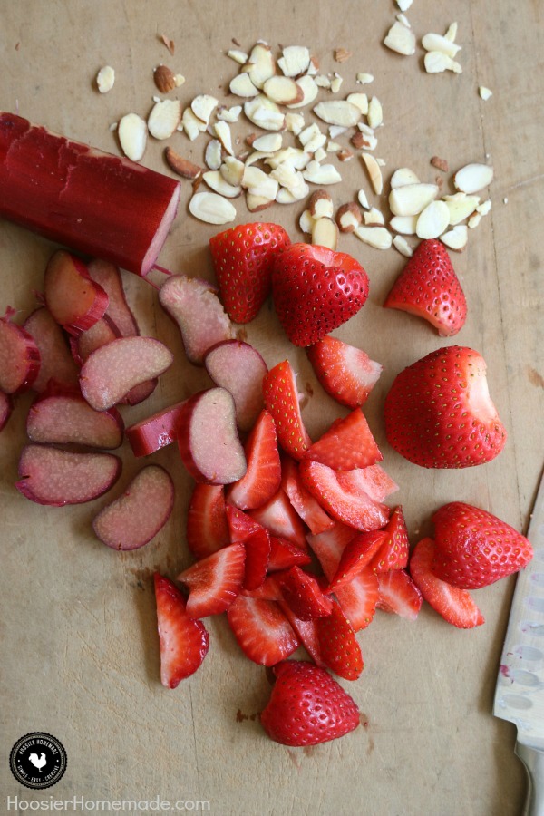 Strawberry Rhubarb Almond Crumble Dessert - simple ingredients + NO mixing for this delicious recipe! The tartness of the rhubarb and the sweetness of the strawberries combined with crushed pineapple send this easy to make dessert over the top! Be sure to save the recipe by pinning to your Recipe Board!