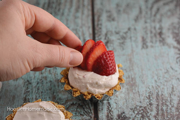 These Easy Mini Strawberry Cheesecakes are as fun to make as they are to eat. Perfect for any occasion! Impress your family and friends - SHH don't tell them they are super easy!