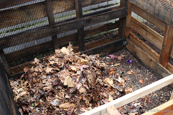 Add leaves to Wooden Pallet Compost Bin