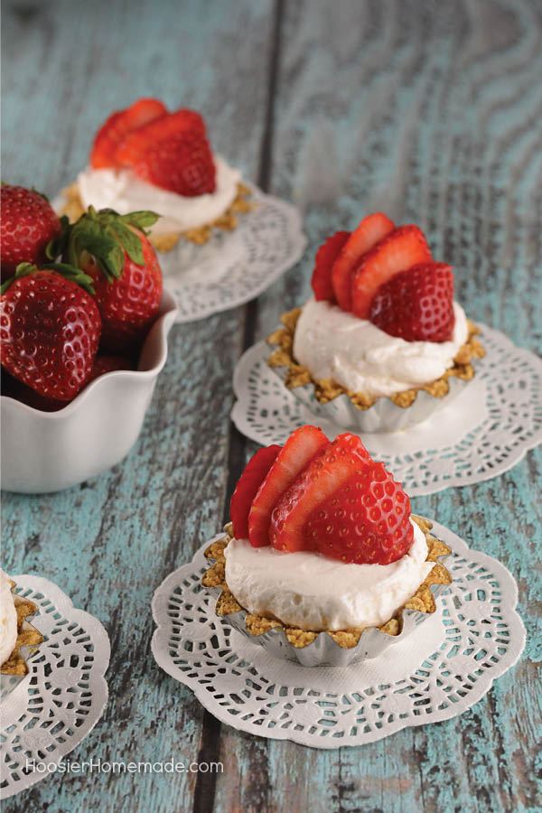 These Easy Mini Strawberry Cheesecakes are as fun to make as they are to eat. Perfect for any occasion! Impress your family and friends - SHH don't tell them they are super easy!