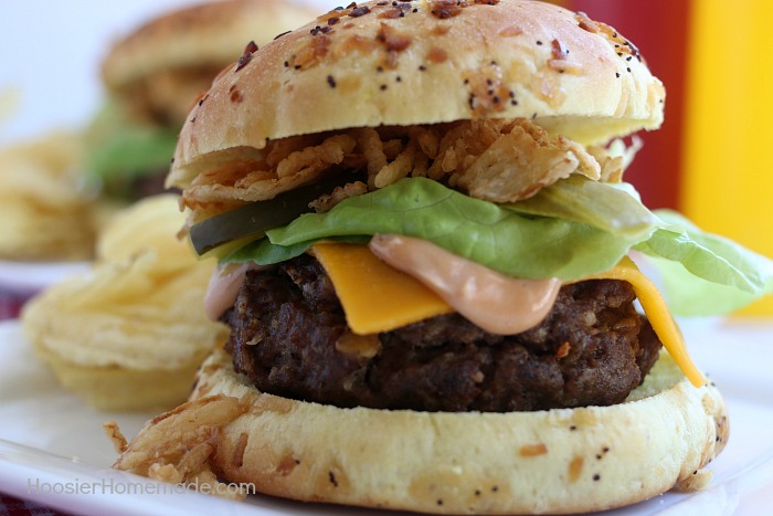 This All-American Barbecue Burger is the BEST you will ever eat! Made with a secret ingredient and piled high with barbecue/mayo sauce, cheese, lettuce and pickles all on a special onion bun! 