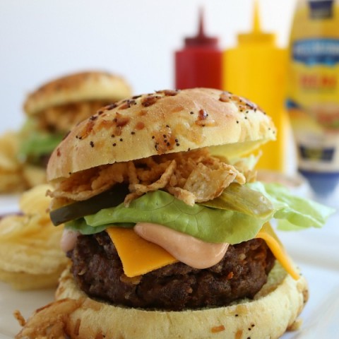 This All-American Barbecue Burger is the BEST you will ever eat! Made with a secret ingredient and piled high with barbecue/mayo sauce, cheese, lettuce and pickles all on a special onion bun!