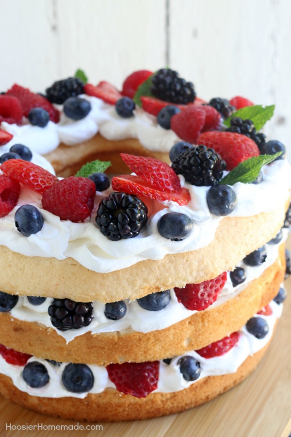 This showstopping Angel Food Cake with Berries takes ONLY 15 minutes to put together! WOW your guests with this amazing and delicious 4th of July Cake Idea or serve for any occasion!