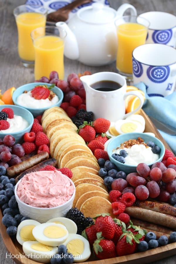 Breakfast Charcuterie Board with pancakes, meat, fruit and yogurt