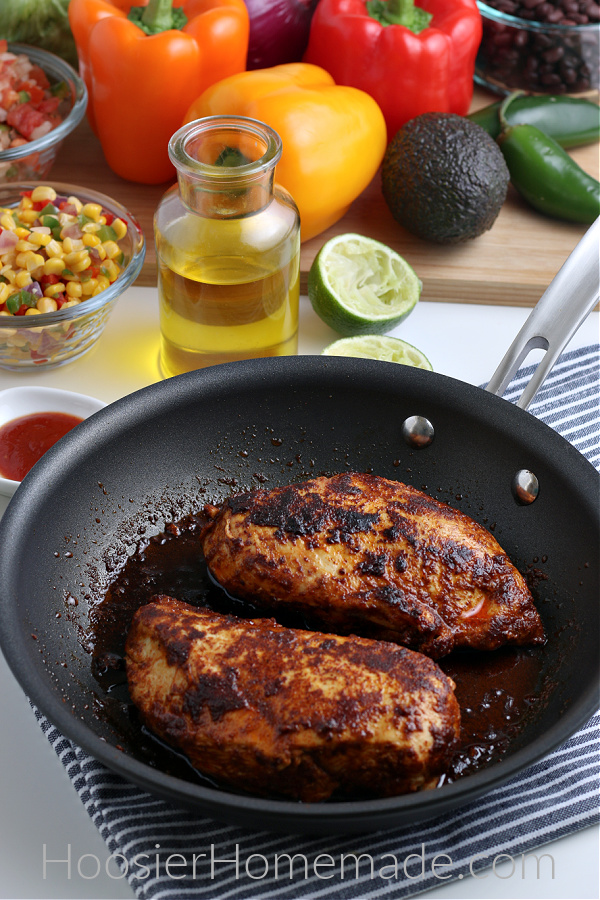 chicken cooked in pan with toppings for burrito bowl recipe