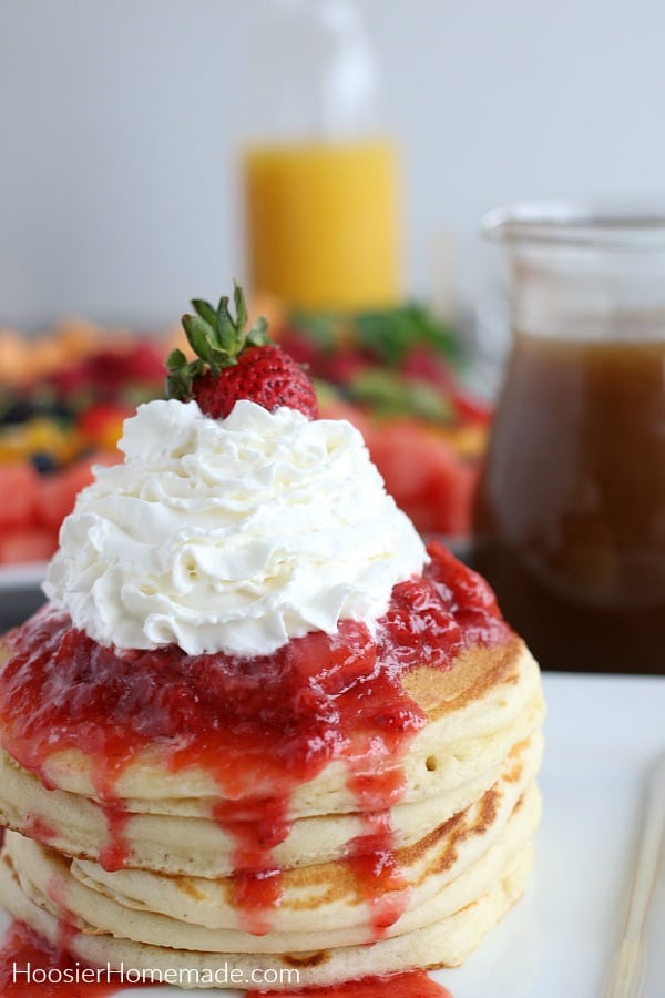Buttermilk Pancakes on plate with strawberries and whip cream