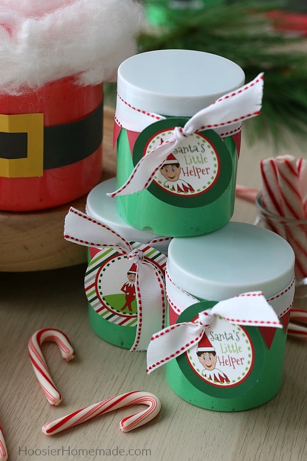 Containers of Christmas Slime decorated in Santa and Elf