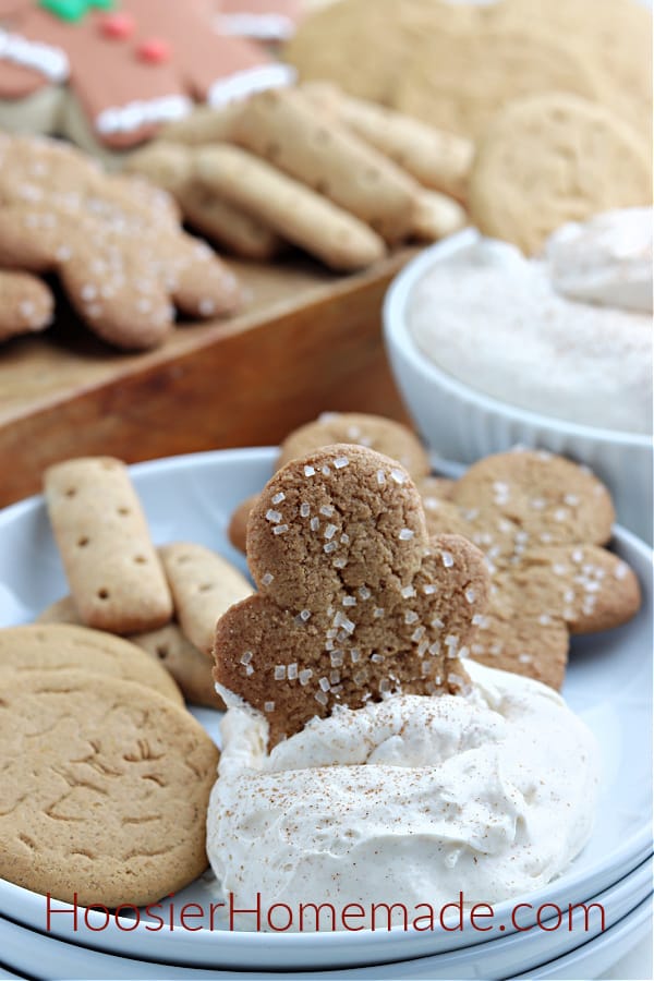eggnog dip on white plate with gingerbread man cookie