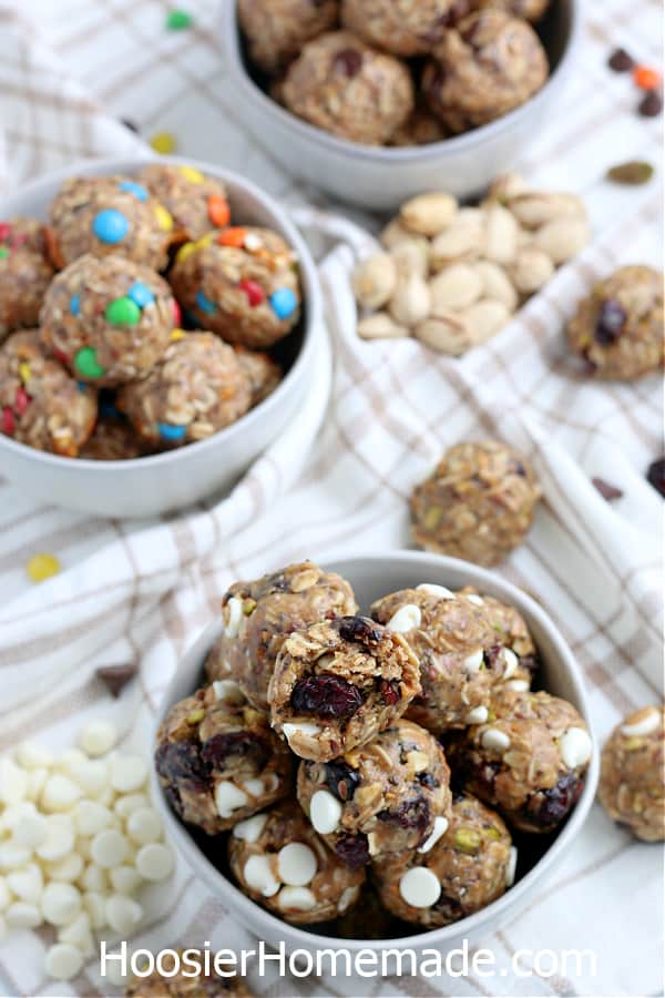 energy balls in gray bowls with chocolate chips and candy