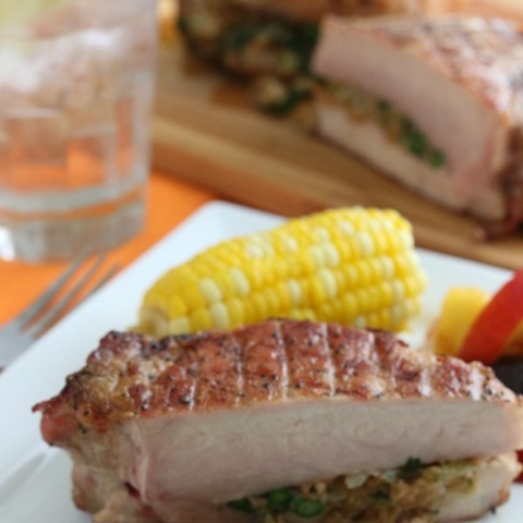 Grilled Stuffed Pork Chops - Packed with flavor and so easy to make! Wow your friends at your next cookout! Shh...don't tell them these Grilled Pork Chops are super easy to make! Click on the photo to grab the recipe! #grillpork