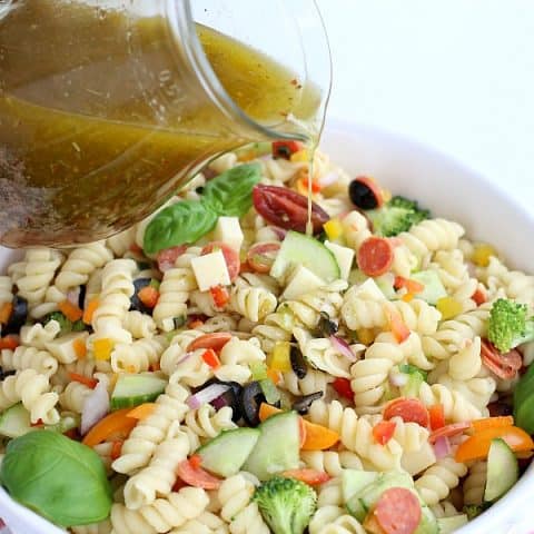 Italian Dressing poured on Pasta Salad