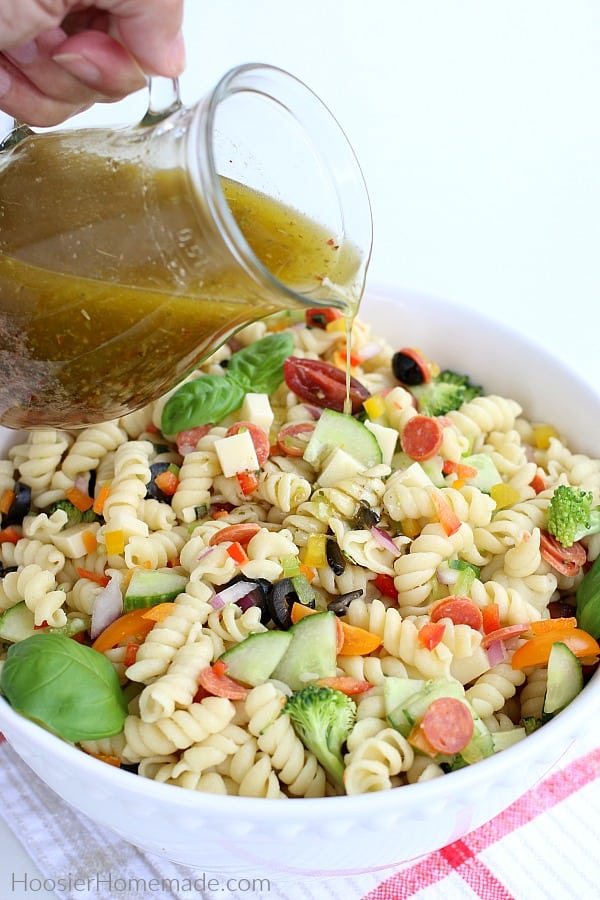 Italian Dressing poured on Pasta Salad