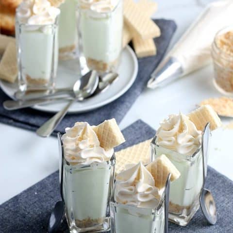 Pudding shots with whip cream and cookies