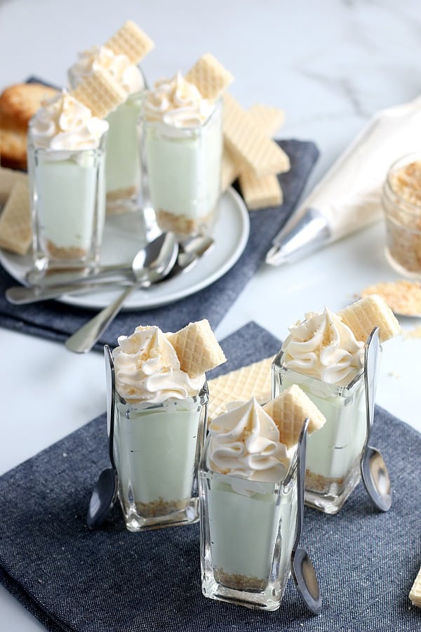 Pudding shots with whip cream and cookies