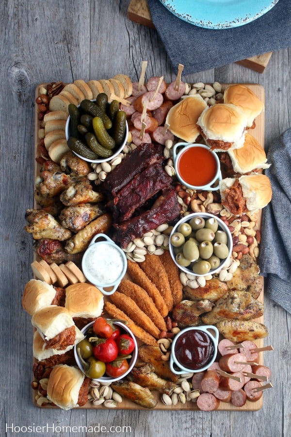 Board with meat snacks pickles olives peppers