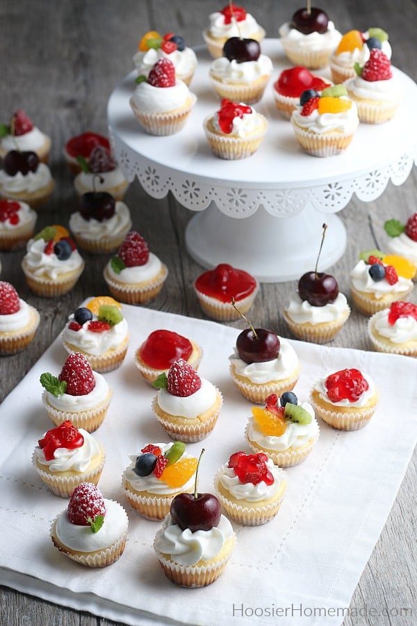 Mini Cheesecakes topped with fresh fruit and whip cream