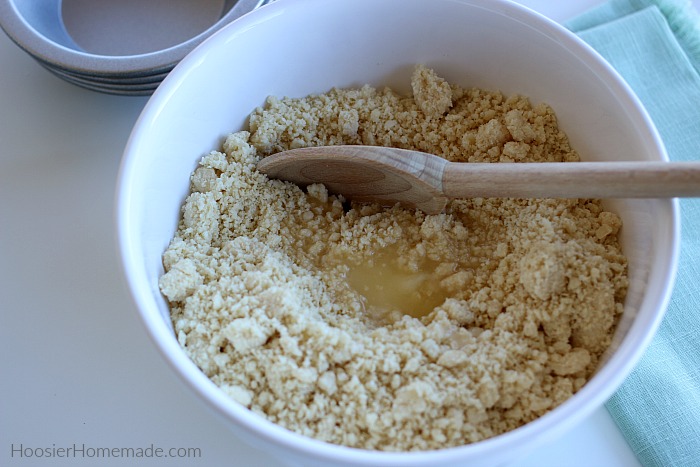 Mix cookie crumbs with butter