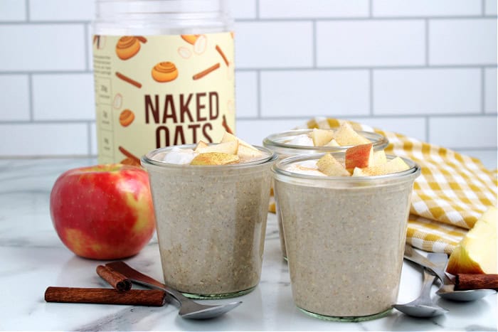 cinnamon roll naked oats from Naked Nutrition made in jars and topped with greek yogurt and apples