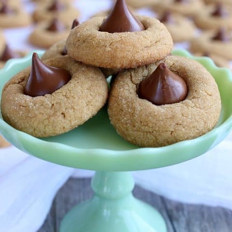 Peanut Butter Blossoms cookies on green stand