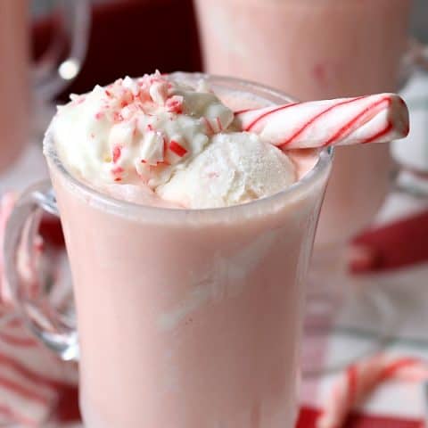 Peppermint Punch in glasses with whip cream and peppermint stick