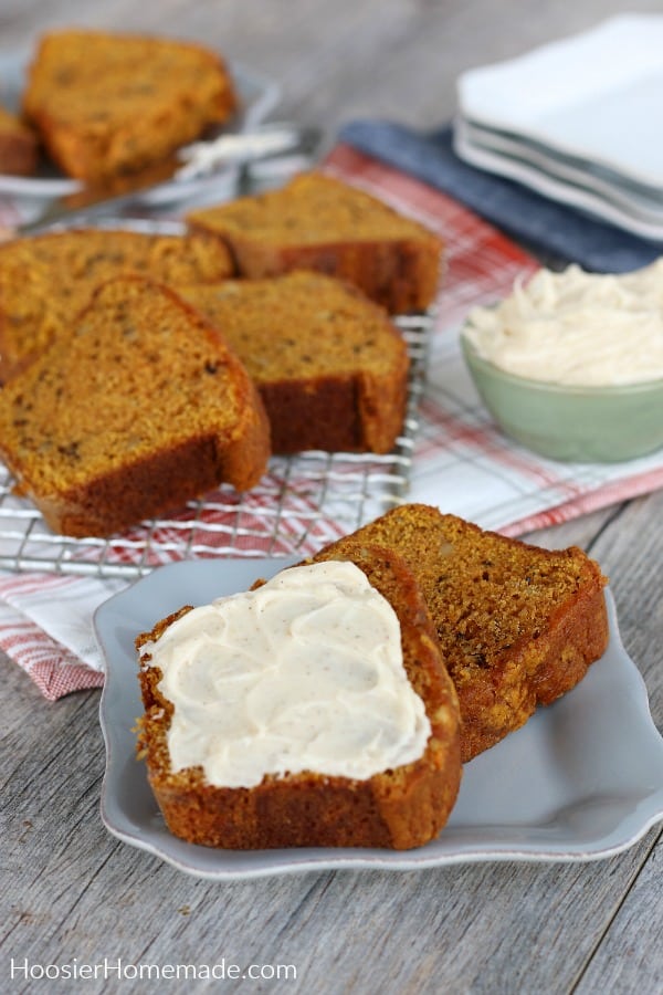 Pumpkin Bread sliced on gray plate with cinnamon butter