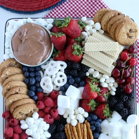 S'mores Dip on tray with fruit, cookies and pretzels