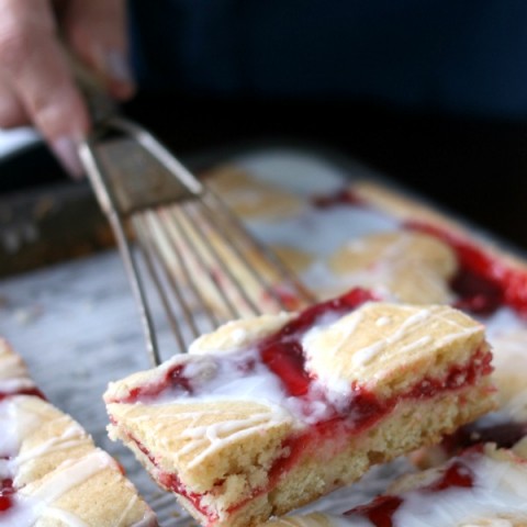 These Strawberry Cobbler Bars will knock your socks OFF! They are super simple to make and taste amazing! Serve them for any occasion, take them to a potluck or easy enough for a weeknight dessert!